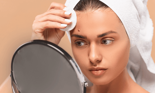 Woman Inspecting Pimple in The Mirror