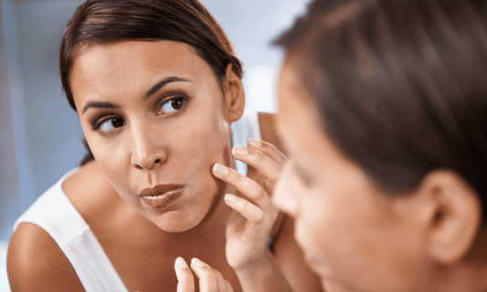 Woman Inspecting Blemish on Face