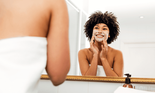 Woman Exfoliating Face in Mirror