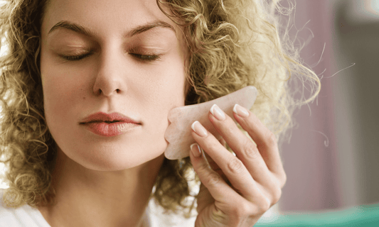 Woman Sculpting Face with Gua Sha